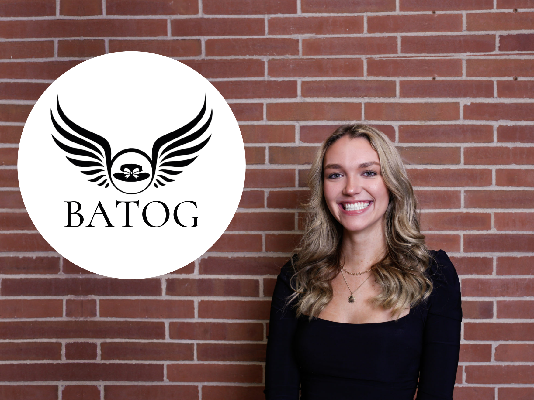 Woman in black top in front of brick wall, smiling at camera next to company logo